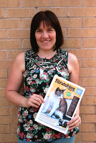 Lady holding Scratching Post cat newsletter